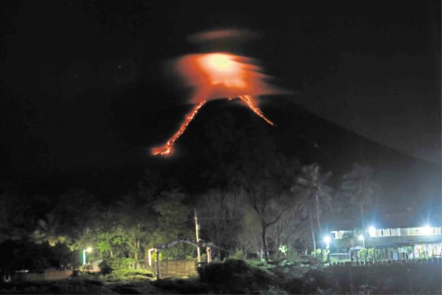 EERIE GLOW With the night sky shrouded by thick clouds, the only visible sign of unrest from Mayon Volcano is an eerie glow from its crater as seen from the Binitayan-Kilicao bridge in Daraga town, Albay province. This photo was taken at 8 p.m. on Monday. —GEORGE GIO BRONDIAL